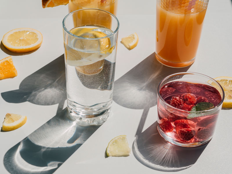 Two cocktails with orange slices around them
